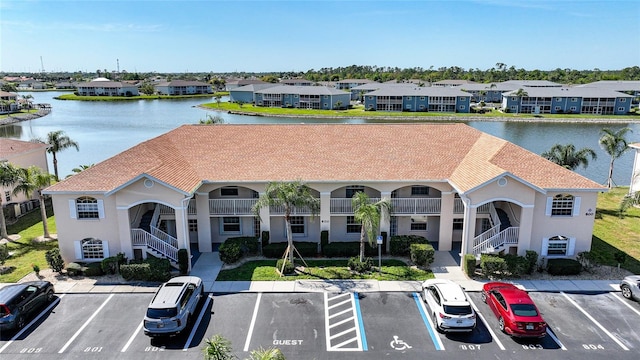 drone / aerial view featuring a water view and a residential view