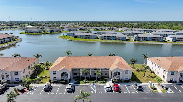 drone / aerial view with a water view and a residential view