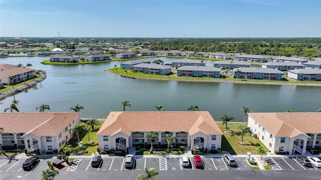 drone / aerial view with a water view and a residential view