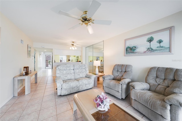 living room featuring a ceiling fan and light tile patterned flooring