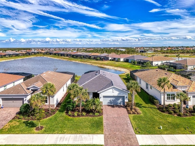 drone / aerial view with a residential view and a water view