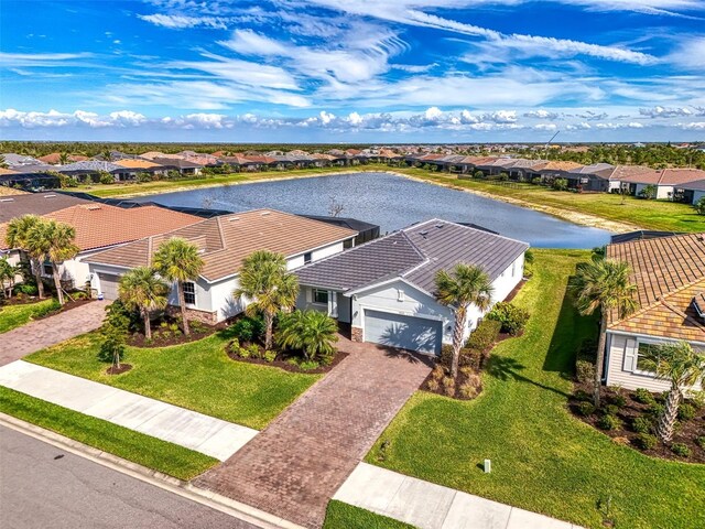 drone / aerial view featuring a water view and a residential view