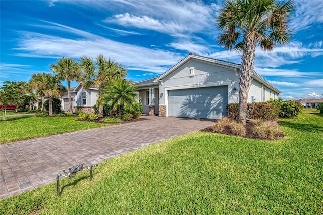 single story home featuring a front lawn, stone siding, an attached garage, and stucco siding