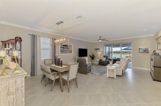 dining area featuring baseboards, visible vents, a ceiling fan, ornamental molding, and light tile patterned flooring