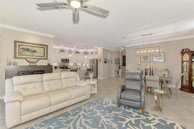 living area with light tile patterned floors, baseboards, and crown molding