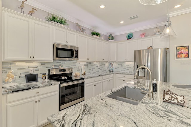 kitchen with visible vents, appliances with stainless steel finishes, white cabinets, and a sink