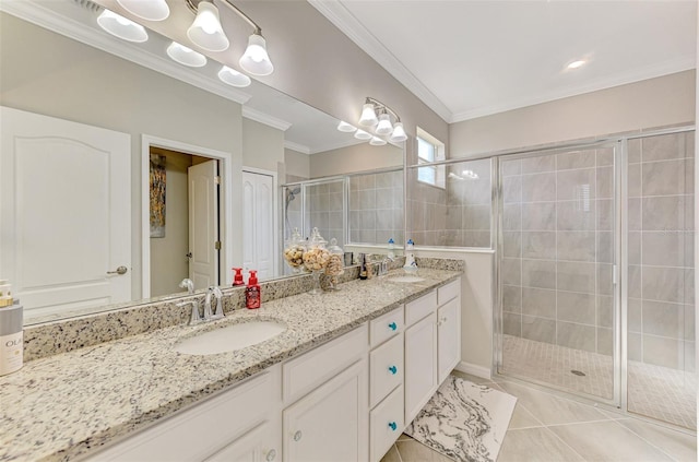 full bathroom featuring double vanity, a stall shower, a sink, and crown molding