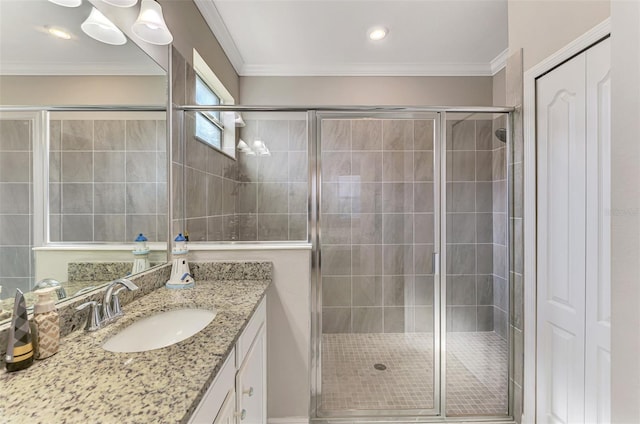 full bath with ornamental molding, a stall shower, and vanity