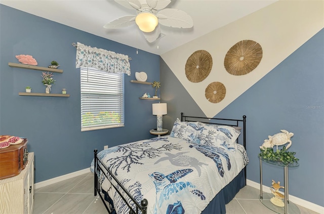 tiled bedroom featuring ceiling fan and baseboards