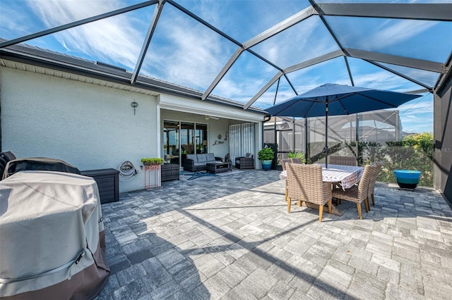 view of patio featuring glass enclosure, outdoor dining area, grilling area, and outdoor lounge area