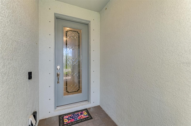 view of exterior entry with stucco siding