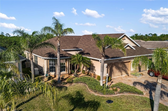 view of front of property with an attached garage, driveway, and stucco siding