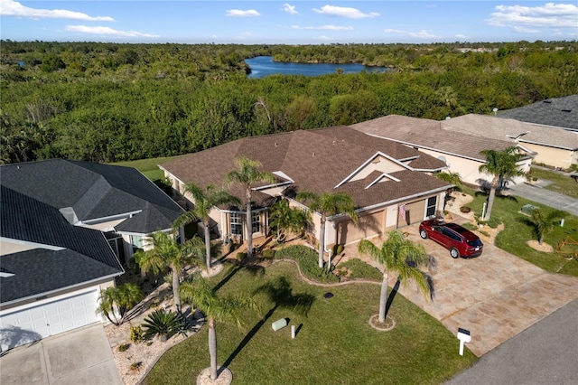 aerial view featuring a water view and a view of trees