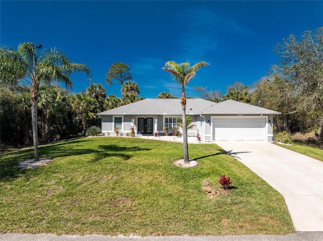 ranch-style home with a garage, concrete driveway, and a front lawn