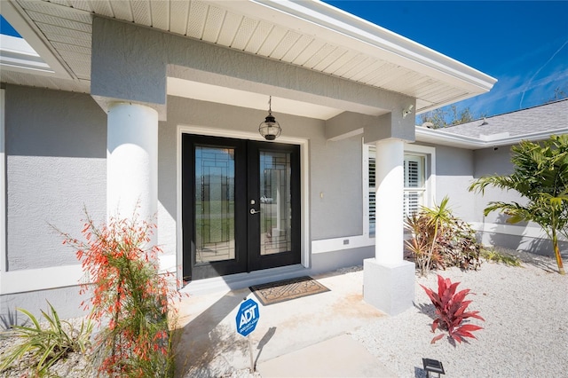 property entrance featuring french doors and stucco siding