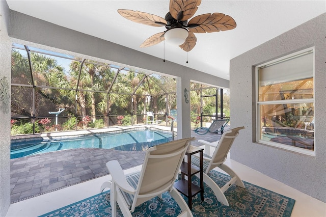 outdoor pool with ceiling fan, a patio, and a lanai