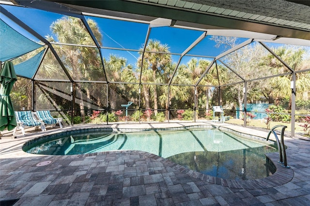 pool featuring a patio area and glass enclosure