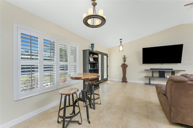 dining space with vaulted ceiling, baseboards, and light tile patterned floors