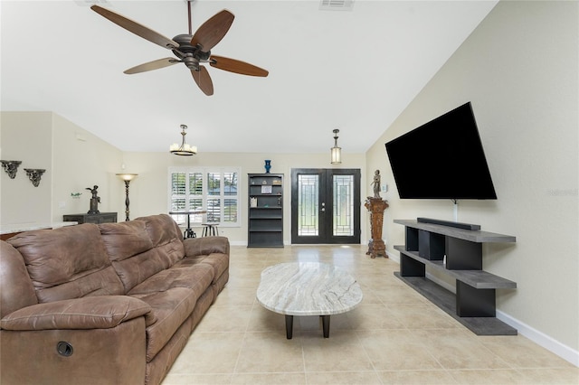 living room featuring light tile patterned floors, baseboards, lofted ceiling, ceiling fan, and french doors