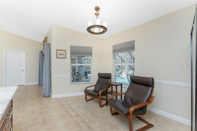 living area with lofted ceiling, a notable chandelier, baseboards, and light tile patterned floors