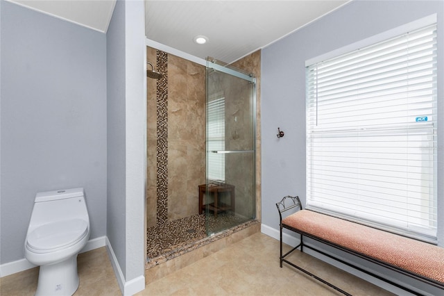 full bath featuring a stall shower, toilet, and baseboards