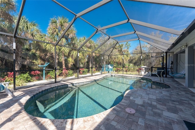 pool with a patio and glass enclosure