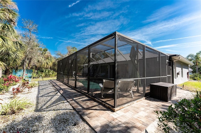 exterior space with a lanai, a patio, and stucco siding