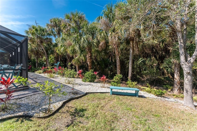 view of yard featuring glass enclosure