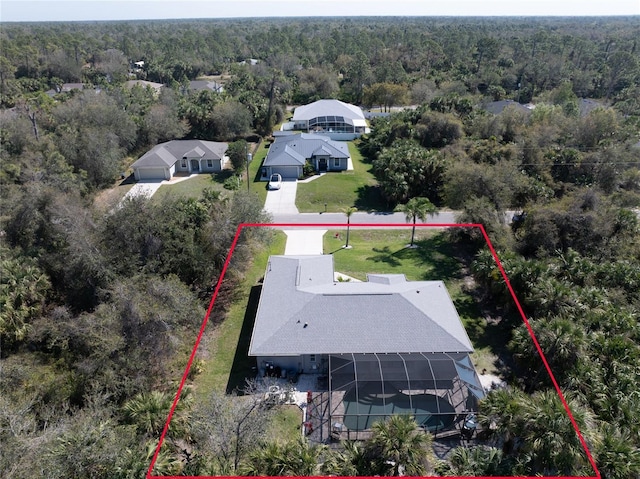 birds eye view of property featuring a wooded view