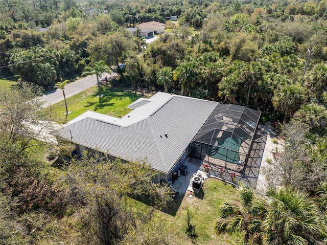 birds eye view of property with a forest view