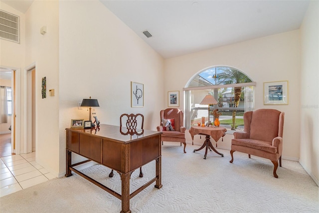 office space with light carpet, light tile patterned flooring, plenty of natural light, and visible vents