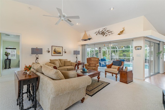 living room with a ceiling fan, high vaulted ceiling, and carpet flooring