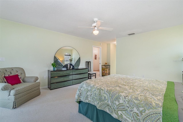 carpeted bedroom with ceiling fan, a textured ceiling, and visible vents