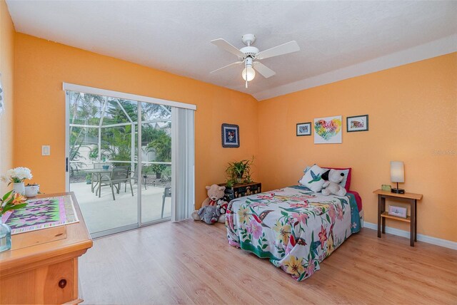 bedroom featuring baseboards, wood finished floors, a ceiling fan, and access to exterior