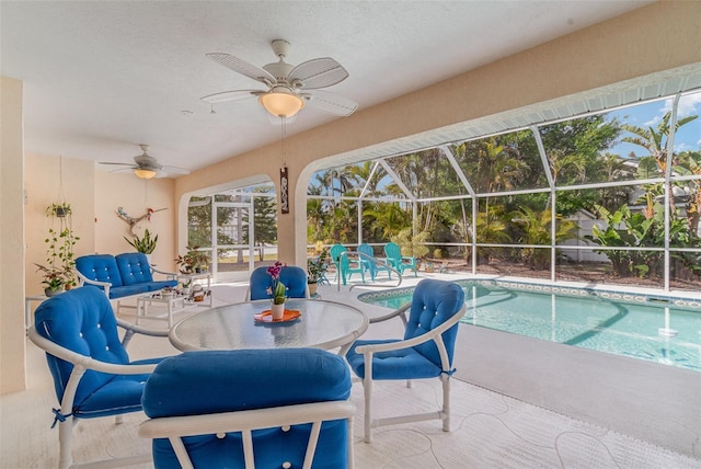 outdoor pool featuring a patio, outdoor dining space, a lanai, and a ceiling fan