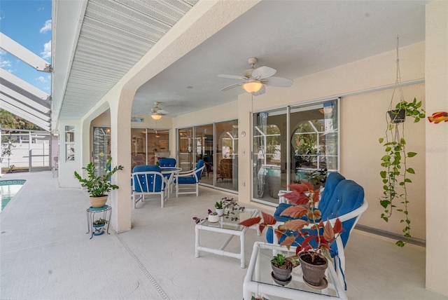 view of patio featuring a ceiling fan, a lanai, and an outdoor pool