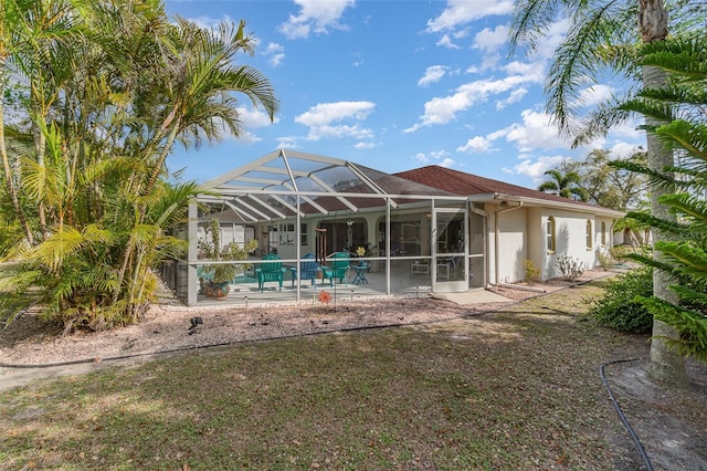 back of property with a lanai, stucco siding, an outdoor pool, and a patio