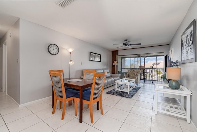 dining room with light tile patterned floors, baseboards, visible vents, and a ceiling fan