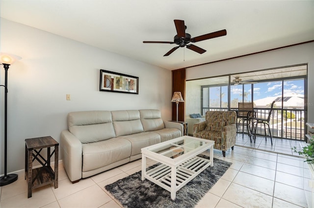 living area featuring ceiling fan and light tile patterned flooring