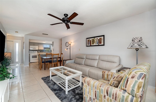 living room featuring light tile patterned flooring and ceiling fan