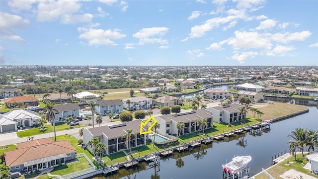 drone / aerial view featuring a residential view and a water view