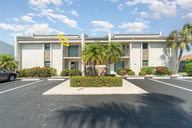 view of building exterior featuring uncovered parking