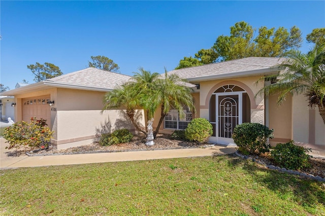 ranch-style house with a front yard, roof with shingles, an attached garage, and stucco siding