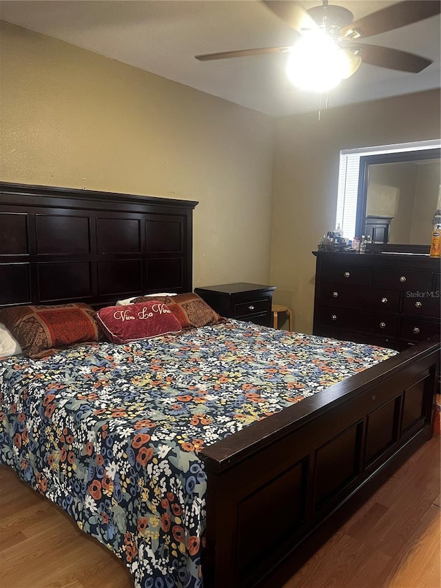 bedroom with light wood-type flooring and ceiling fan