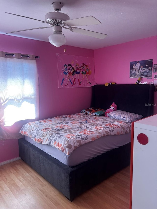 bedroom with light wood-type flooring and a ceiling fan