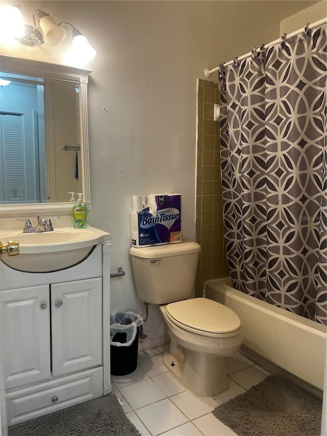 bathroom featuring toilet, tile patterned flooring, shower / bath combination with curtain, and vanity