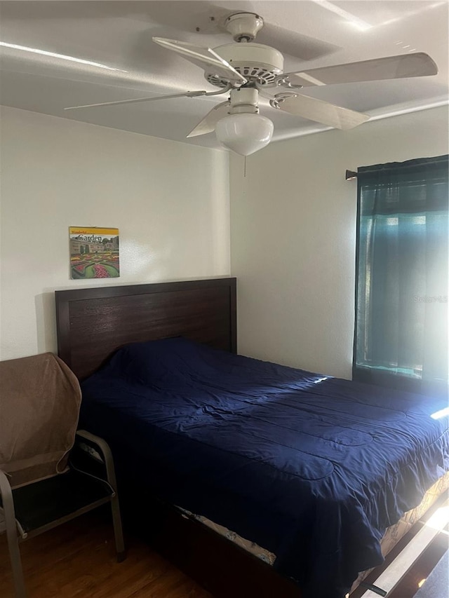 bedroom with ceiling fan and wood finished floors