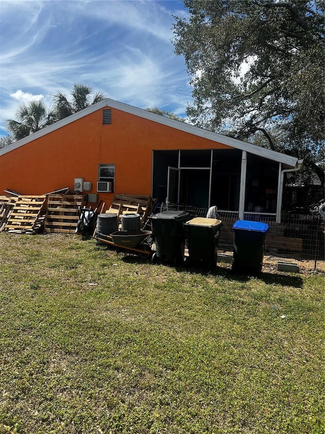 rear view of house featuring a yard