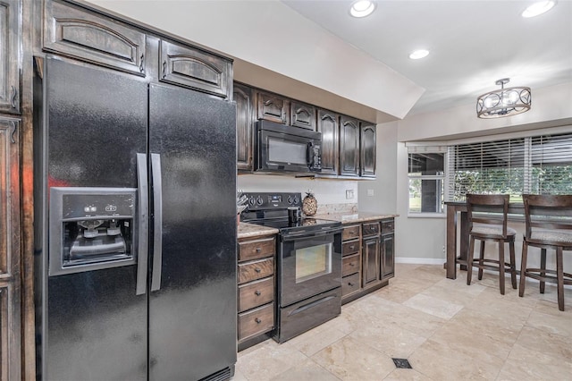 kitchen with baseboards, light stone counters, dark brown cabinets, black appliances, and recessed lighting