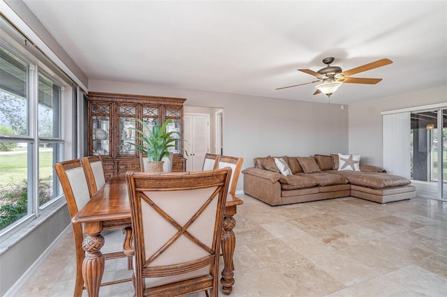 dining room featuring ceiling fan and baseboards